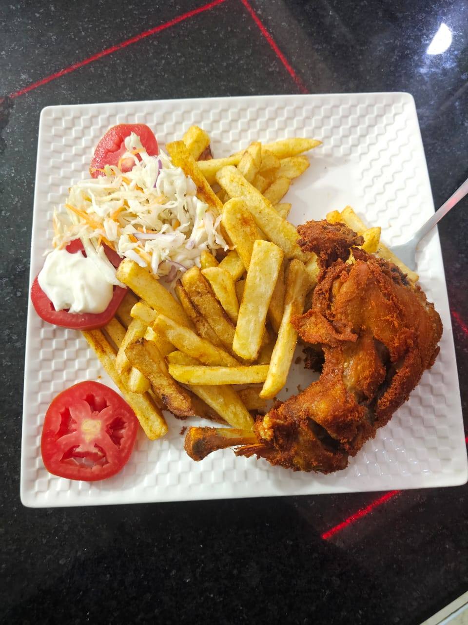 Whole grilled fish choma served with lemon