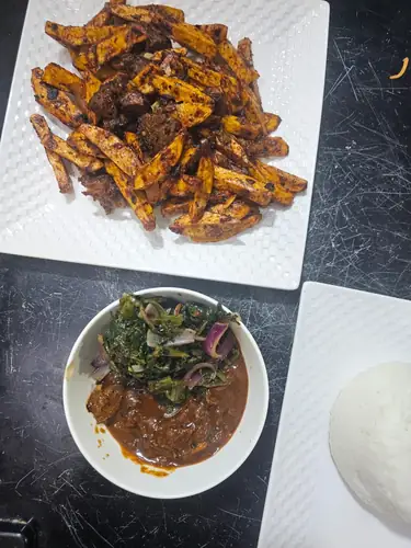 Mshikaki grilling over charcoal at Golden Taste Corner, Rwandan restaurant in Nairobi