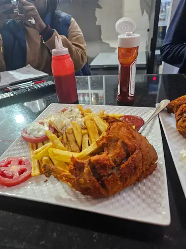 Nyama choma sizzling platter at Golden Taste Corner, Rwandan restaurant in Nairobi